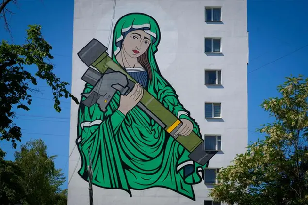 A mural depicts an image known as \\\"Saint Javelina\\\"- Virgin Mary cradling a US-made FGM-148 anti-tank weapon Javelin - on a living house wall in Kyiv, Ukraine, Monday, June 6, 2022. These missiles are among the arms being sent by Western allies to Ukrainian forces to aid in their fight against the Russian invaders. Javelin is widely considered a symbol of Ukraine's defence.(AP Photo/Efrem Lukatsky)