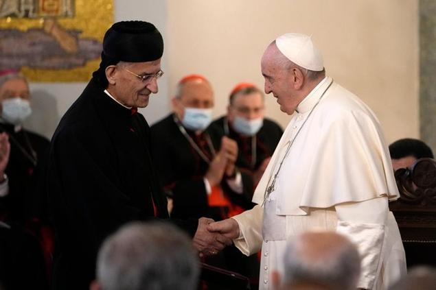 Pope Francis, right, shakes hands with Cardinal Bechara Boutros Rai during a ceremony at the Maronite Cathedral of Our Lady of Graces in Nicosia, Cyprus, Thursday, Dec. 2, 2021. Pope Francis' trip to Cyprus and Greece is drawing new attention to the plight of migrants on Europe's borders and the disconnect between Francis' Gospel-driven call for countries to welcome and integrate them and front-line governments that are increasingly unwilling or unable to let them in. (AP Photo/Alessandra Tarantino)