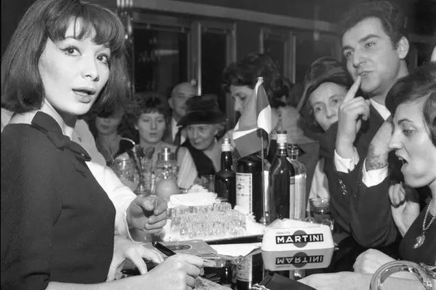 FILE - In this Nov. 8, 1960 file photo, French actress and singer Juliette Greco signs records for her fans during a cocktail party held in her honour in Milan, Italy. French media say Juliette Greco, singer, actress, cultural icon and muse to Existentialist philosophers of Franceâ€™s post-War period, has died aged 93. They said Wednesday, Sept. 23, 2020 Greco died in her Ramatouelle house in the south of France, near Saint Tropez.. (AP Photo/Raoul Fornezza, file)