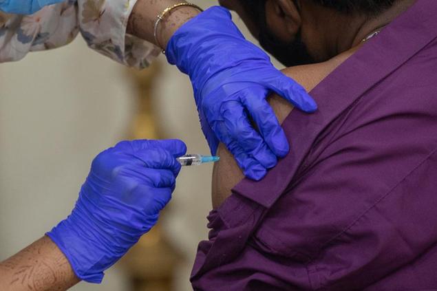 A man receives Covishield COVID-19 vaccine at a vaccination center in Mumbai, India, Monday, Nov. 29, 2021. (AP Photo/Rafiq Maqbool)