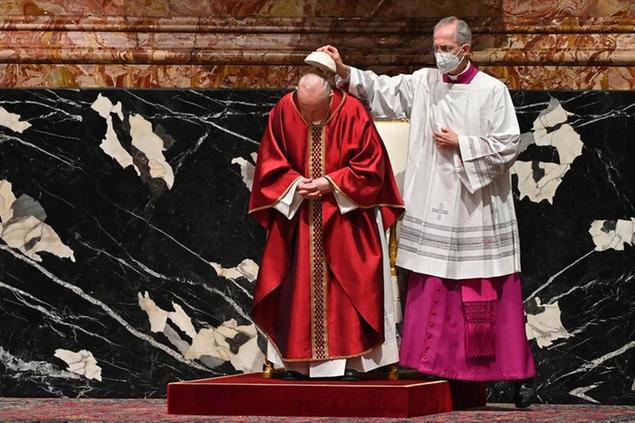 Master of Pontifical Liturgical Ceremonies, Italian priest Guido Marini assists Pope Francis as he celebrates Good Friday Mass for the Passion of Christ, at St. Peter's Basilica, at the Vatican, Friday, April 2, 2021, during the Covid-19 coronavirus pandemic. (Andreas Solaro/Pool photo via AP)
