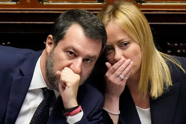 Italian Premier Giorgia Meloni, right, talks to Infrastructures Minister Matteo Salvini after addressing the lower Chamber ahead of a confidence vote for her Cabinet, Tuesday, Oct. 25, 2022. Giorgia Meloni, whose party with neo-fascist roots finished first in recent elections, is Italy's first far-right premier since the end of World War II. She is also the first woman to serve as Italian premier. (AP Photo/Alessandra Tarantino)