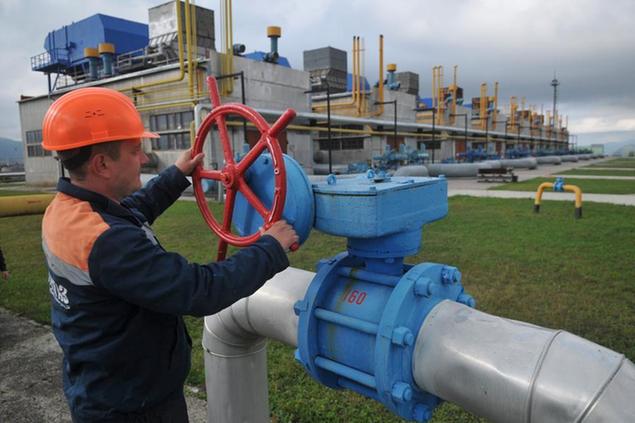 FILE - A worker at a gas facility in Volovets, western Ukraine, adjusts a valve on Wednesday, Oct. 7, 2015. Ukrainian and Russian officials say final details have been worked out for a contract that will continue shipments of Russian gas to European markets. The Ukrainian presidential administration says details will be announced on Saturday, Dec. 21, 2019. (AP Photo/Pavlo Palamarchuk, File)