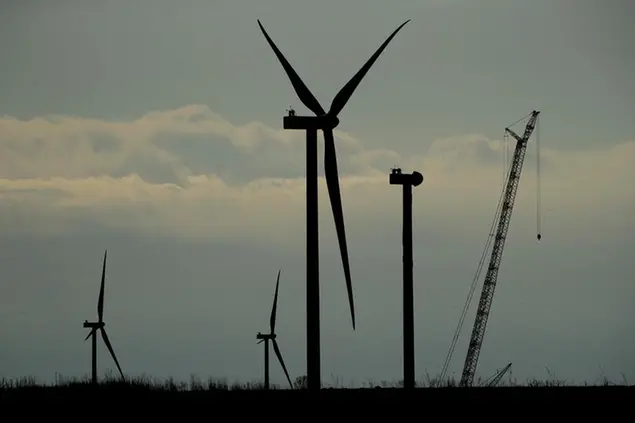 Wind turbines stand in various stages of completion at the Reading Wind Facility in Reading, Kan., on Thursday, April 23, 2020. Although the wind power project has experienced some delays in delivery of some foreign-sourced parts and had to implement social distancing measures, the project is on schedule to be completed in the next few weeks. (AP Photo/Charlie Riedel)