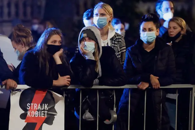(Ragazze polacche davanti alla casa di Jaroslaw Kaczynski, a Varsavia, per manifestare il loro dissenso sulla sentenza anti-aborto)