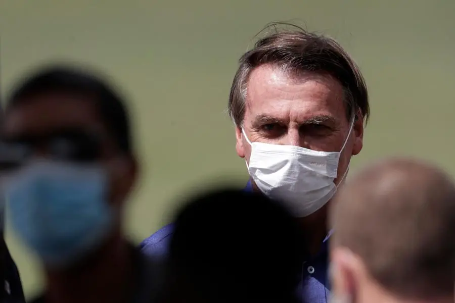 Brazil's President Jair Bolsonaro celebrates his 66th birthday with supporters at the Alvorada Palace, the official presidential residence, in Brasilia, Brazil, Sunday, March 21, 2021. (AP Photo/Eraldo Peres)