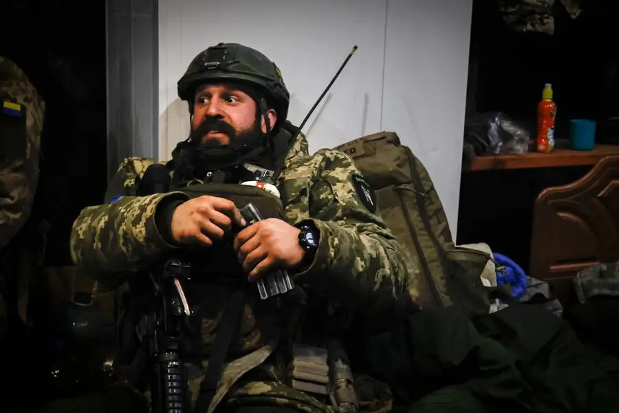 A Ukrainian officer sits in a shelter in Soledar, the site of heavy battles with Russian forces in the Donetsk region, Ukraine, Sunday, Jan. 8, 2023. (AP Photo/Roman Chop)