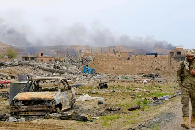 File photo taken in March 2019 shows a militiaman walking in Baghuz, eastern Syria, the last hideout of the Islamic State terror group. (Kyodo via AP Images) ==Kyodo