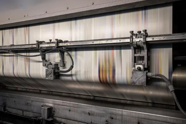 PRODUCTION - 19 April 2021, Bavaria, Nuremberg: A paper web runs through a rotogravure press at the Prinovis printing plant. The Nuremberg-based large-scale printing plant of the Prinovis Group, which is part of the Bertelsmann Group, will close on April 30, 2021. Photo by: Daniel Karmann/picture-alliance/dpa/AP Images