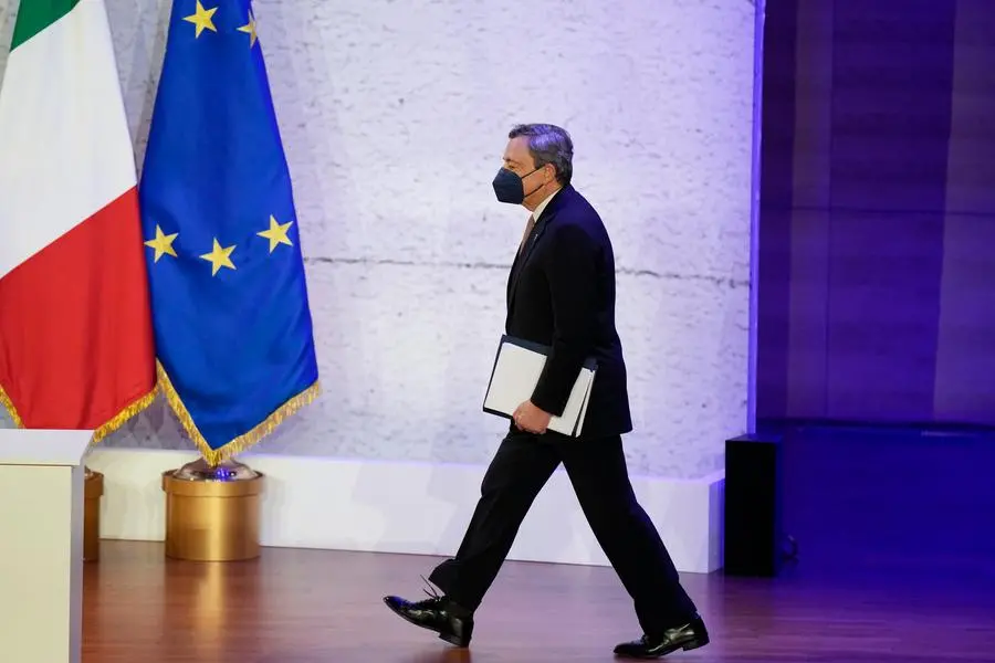 Italy\\\\'s Prime Minister Mario Draghi arrives for a press conference at the La Nuvola conference center for the G20 summit in Rome, Sunday, Oct. 31, 2021. Leaders of the world\\\\'s biggest economies made a compromise commitment Sunday to reach carbon neutrality \\\\\\\"by or around mid-century\\\\\\\" as they wrapped up a two-day summit that was laying the groundwork for the U.N. climate conference in Glasgow, Scotland. (AP Photo/Andrew Medichini)