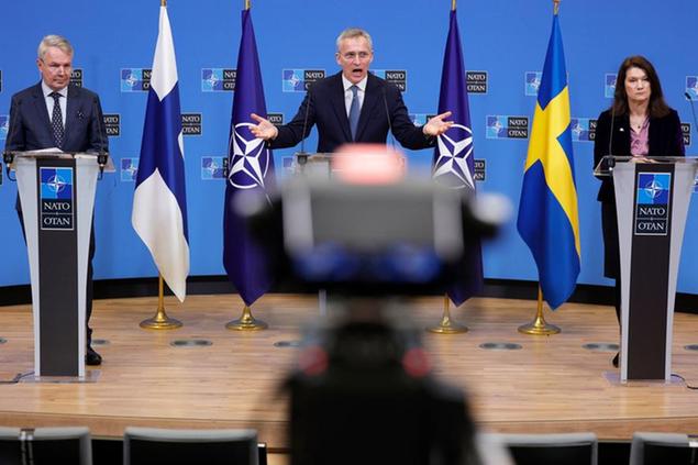 NATO Secretary General Jens Stoltenberg, center, participates in a media conference with Finland's Foreign Minister Pekka Haavisto, left, and Sweden's Foreign Minister Ann Linde, right, at NATO headquarters in Brussels, Monday, Jan. 24, 2022. (AP Photo/Olivier Matthys)