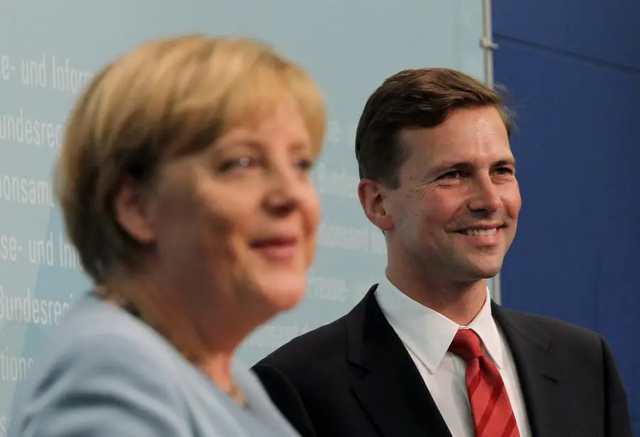 BERLIN - AUGUST 16: German Chancellor Angela Merkel and new German government spokesman Steffen Seibert speak at Seibert's official presentation as new spokesman at the Federal Press Office on August 16, 2010 in Berlin, Germany. Seibert replaces outgoing spokesman Ulrich Wilhelm. (Photo by Sean Gallup/Getty Images)