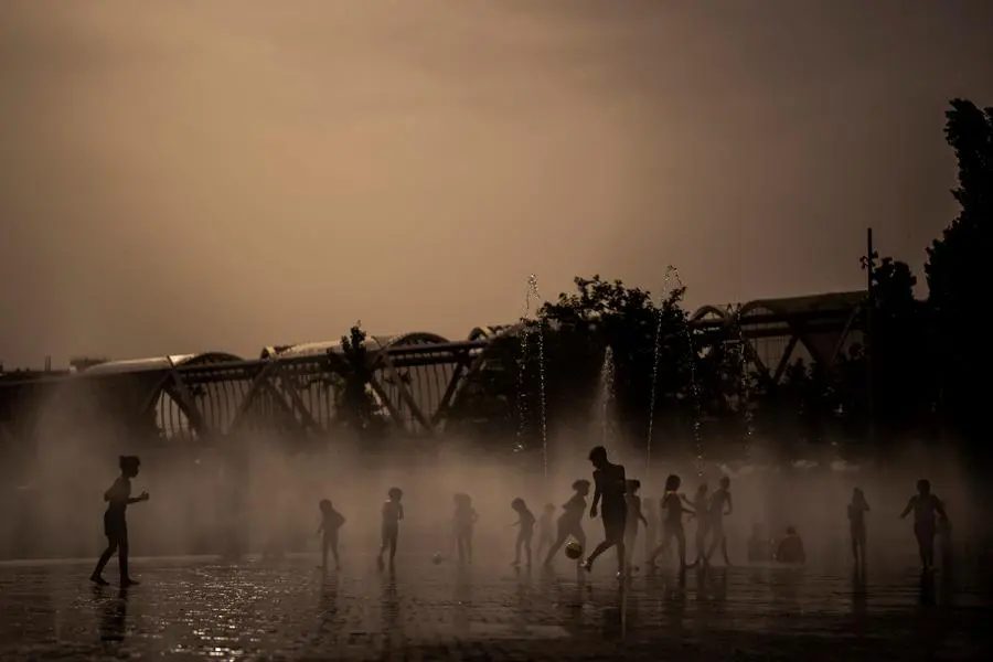 Children cool off in a fountain in a park by the river in Madrid, Spain, Wednesday, June 15, 2022. Spain's weather service says a mass of hot air from north Africa is triggering the country's first major heatwave of the year with temperatures expected to rise to 43 degrees Celsius (109 degrees Fahrenheit) in certain areas. (AP Photo/Manu Fernandez)