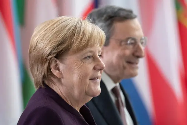 28 October 2019, Hessen, Frankfurt/Main: Federal Chancellor Angela Merkel (CDU, l) and ECB President Mario Draghi arrive in the ECB's foyer for a ceremony marking the change at the top of the ECB. Photo by: Boris Roessler/picture-alliance/dpa/AP Images