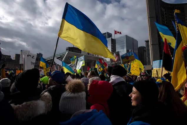 Thousands gather to show their support for the people of Ukraine following an invasion by Russia, in Toronto, Sunday, Feb. 27, 2022. (Chris Young/The Canadian Press via AP)