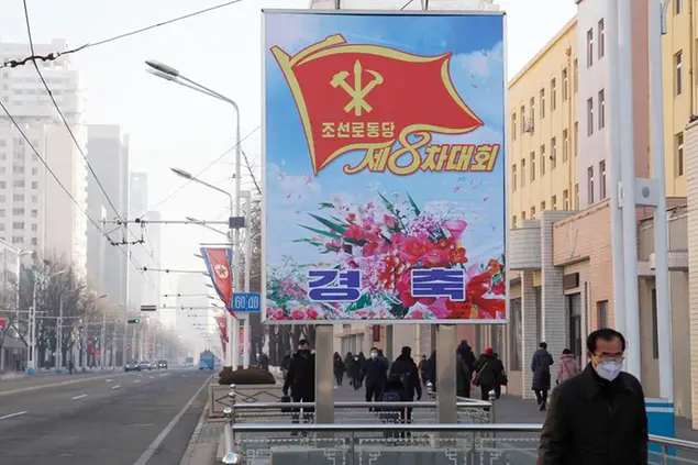 People walk past a billboard announcing the 8th Congress of the Workers\\\\' Party along a main street of the Central District in Pyongyang, North Korea, on Wednesday, Jan., 6, 2021. The Workers’ Party Congress is one of the North’s biggest propaganda spectacles and is meant to help leader Kim Jong Un show his people that he’s firmly in control and boost unity in the face of COVID-19 and other growing economic challenges. (AP Photo/Cha Song Ho)