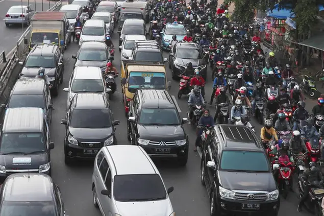 Vehicles are caught in a congestion as the flow of traffic of the capital significantly increases during a rush hour in Jakarta, Indonesia, Monday, June 8, 2020. Indonesiaâ€™s capital of Jakarta, the city hardest hit by the new coronavirus, has partly reopened after two months of partial lockdown as the worldâ€™s fourth most populous nation braces to gradually reopen its economy. (AP Photo/Achmad Ibrahim)