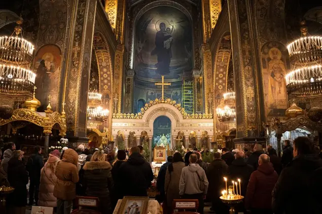 People pray in the St. Volodymyr Cathedral on Orthodox Christmas eve in Kyiv, Ukraine, Friday, Jan. 6, 2023. (AP Photo/Efrem Lukatsky)