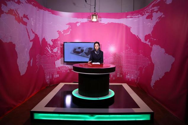 FILE - Basira Joya, 20, presenter of the news program sits during recording at the Zan TV station (women's TV) in Kabul, Afghanistan, May 30, 2017. Afghanistan's Taliban rulers ordered all female presenters on TV channels to cover their faces on air, the country's biggest media outlet said Thursday, May 19, 2022. (AP Photo/Rahmat Gul, File)