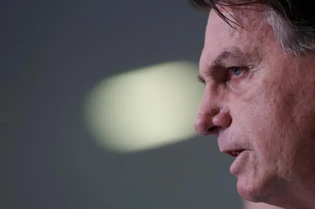 Brazilian President Jair Bolsonaro gives a press conference to announce the start of emergency aid for the COVID-19 pandemic at Planalto presidential palace in Brasilia, Brazil, Wednesday, March 31, 2021. (AP Photo/Eraldo Peres)