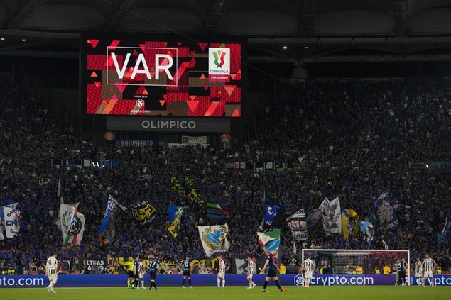 The big screen displays a VAR review message during the Italian Cup final soccer match between Juventus and Inter Milan at the Stadio Olimpico in Rome, Italy, Wednesday, May 11, 2022. (AP Photo/Alessandra Tarantino)