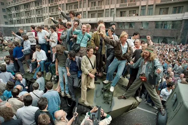 FILE - In this Monday, Aug. 19, 1991 file photo, a crowd gathers around a personnel carrier as some people climb aboard the vehicle and try to block its advance near Red Square in downtown Moscow, Russia. The August 1991 coup that briefly ousted Soviet leader Mikhail Gorbachev collapsed in just three days, precipitating the breakup of the Soviet Union that plotters said they were trying to prevent. (AP Photo/Boris Yurchenko, File)