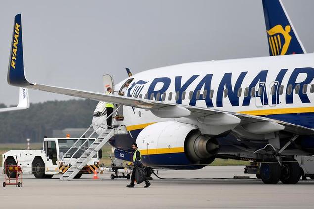 FILE - A Ryanair plane parks at the airport in Weeze, Germany, Sept. 12, 2018. Budget airline Ryanair says it's forcing South African travellers to the U.K. to do a test in the Afrikaans language to prove their nationality in an apparent effort to weed out those with phony passports. It confirmed Monday, June 6, 2022 it's administering the quiz after reports about it circulated on the weekend, sparking anger among travellers. (AP Photo/Martin Meissner, File)