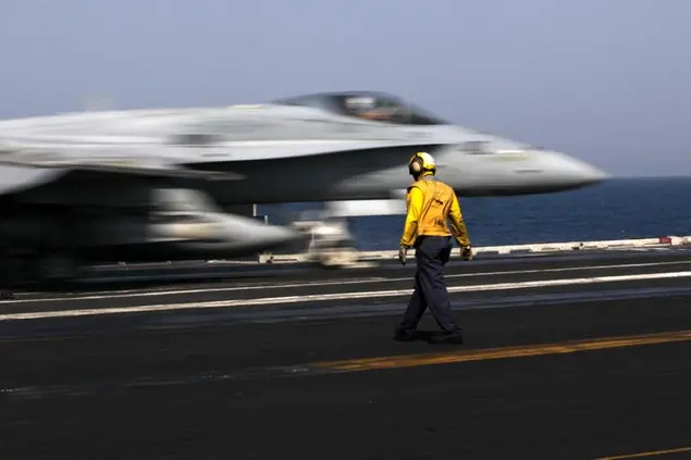 A U.S. F/A-18 fighter jet takes off for Iraq from the flight deck of the U.S. Navy aircraft carrier USS George H.W. Bush, in the Persian Gulf, Monday, Aug. 11, 2014. U.S. military officials say American fighter aircraft struck and destroyed several vehicles Sunday that were part of an Islamic State group convoy moving to attack Kurdish forces defending the northeastern Iraqi city of Irbil. (AP Photo/Hasan Jamali)