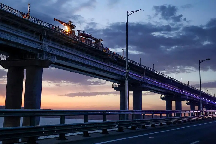 Workers repair the railway part of the Crimean Bridge connecting Russian mainland and Crimean peninsula over the Kerch Strait, in Kerch, Crimea, Saturday, Oct. 8, 2022. Russian authorities say a truck bomb has caused a fire and the collapse of a section of a bridge linking Russia-annexed Crimea with Russia. The bridge is a key supply artery for Moscow's faltering war effort in southern Ukraine. (AP Photo)
