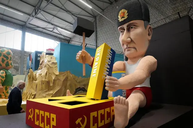 A carnival float depicts Russia's president Vladimir Putin playing with building blocks like the Ukraine to restore the Soviet Union at the presentation of this years satirical carnival floats for the Rose Monday Parade in Cologne, Germany, Tuesday, Feb. 22, 2022. Due to the coronavirus pandemic, this year's parade will take place in Cologne's soccer stadium with just 8000 spectators on the tribunes instead of hundreds of thousands in the streets of the carnival capital Cologne on Shrove Monday. (AP Photo/Martin Meissner)