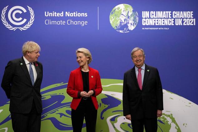 British Prime Minister Boris Johnson, left, and United Nations Secretary General Antonio Guterres, right, greet European Commission President Ursula von der Leyen during arrivals at the COP26 U.N. Climate Summit in Glasgow, Scotland, Monday, Nov. 1, 2021. The U.N. climate summit in Glasgow gathers leaders from around the world, in Scotland's biggest city, to lay out their vision for addressing the common challenge of global warming. (AP Photo/Alastair Grant, Pool)