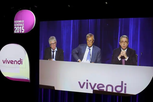 Vivendi Chief Financial Officer Herve Philippe, left, chairman Vincent Bollore, center, and chairman of the Management Board Arnaud de Puyfontaine are seen on a giant screen during Vivendi annual shareholders meeting, Friday, April 17, 2015 in Paris, France. Vivendi is a French media group. (AP Photo/Jacques Brinon)
