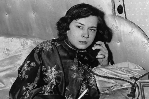 Patricia Highsmith 27, uses the phone in her London apartment, Feb. 16, 1951, shortly after her arrival from America. Her first novel, â€œStrangers on a Trainâ€, was acclaimed by American critics and a film of the book is now being made in Hollywood. Shortly after her arrival in London she went out to buy new English publications because she likes to read at least one book every night before going to sleep. (AP Photo)
