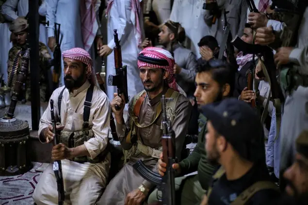epa12244490 Armed men gather inside the Syrian Tribes and Clans Council headquarters in Idlib, Syria, 18 July 2025 during the announcement of the general mobilization in support of Bedouin tribes in Sweida. The council announced a general mobilization, stating that some of its members had begun moving south to “support the Bedouin tribes” amid ongoing tensions and clashes in the region. EPA/BILAL AL HAMMOUD