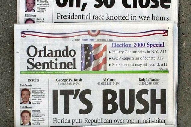 FILE - This Nov. 8, 2000 file photo shows Orlando Sentinel election night headlines The first headline was, \\\"Oh, so close,\\\" followed by \\\"IT'S BUSH,\\\" then \\\"IS IT BUSH?\\\" and lastly \\\"CONTESTED.\\\" The presidential election is still undecided while the nation waits for Florida's final vote count. The mere mention of the 2000 election unsettles people in Palm Beach County. The county\\u2019s poorly designed \\u201Cbutterfly ballot\\u201D confused thousands of voters, arguably costing Democrat Al Gore the state, and thereby the presidency. Gore won the national popular vote by more than a half-million ballots. But George W. Bush became president after the Supreme Court decided, 5-4, to halt further Florida recounts, more than a month after Election Day. Bush carried the state by 537 votes, enough for an Electoral College edge, and the White House. (AP Photo/Peter Cosgrove, File)
