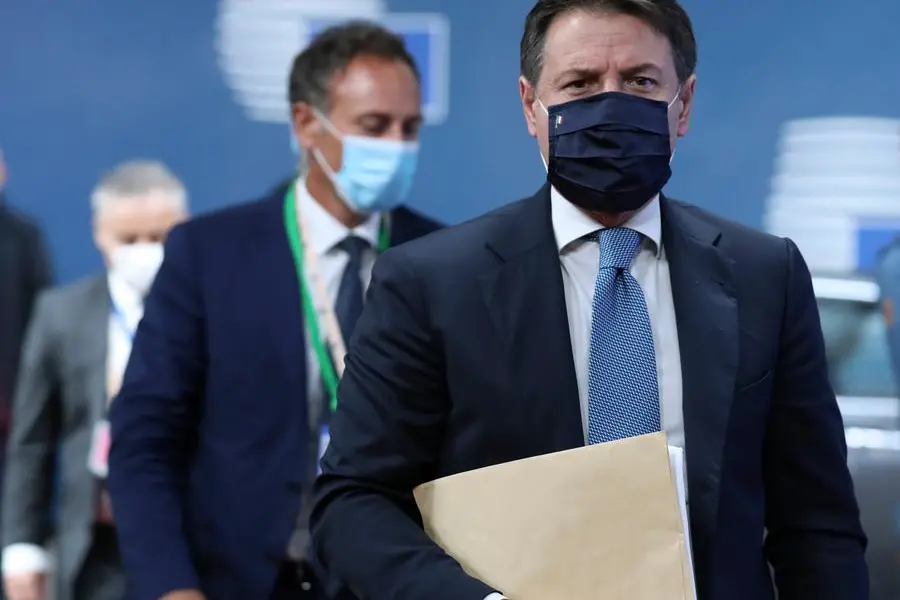 Italy's Prime Minister Giuseppe Conte arrives for an EU summit at the European Council building in Brussels, Thursday, Oct. 1, 2020. European Union leaders are meeting to address a series of foreign affairs issues ranging from Belarus to Turkey and tensions in the eastern Mediterranean. (Aris Oikonomou, Pool via AP)