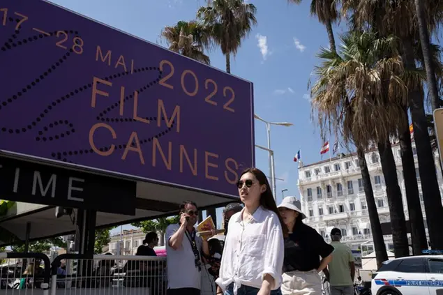 People walk by a festival centre prior to the 75th international film festival, Cannes, southern France, Monday, May 16, 2022.The Cannes film festival runs from May 17th until May 28th 2022. (AP Photo/Petros Giannakouris)