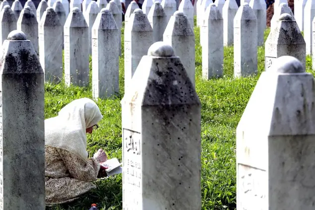 epa10739020 A Bosnian Muslim woman prays during a funeral ceremony for thirty newly-identified Bosnian Muslim victims, at the Potocari Memorial Center and Cemetery, in Srebrenica, Bosnia and Herzegovina, 11 July 2023.The burial was part of a memorial ceremony to mark the 28th anniversary of the Srebrenica genocide, considered the worst atrocity of Bosnia's 1992-95 war. More than 8,000 Muslim men and boys were executed in the 1995 killing spree after Bosnian Serb forces overran the town. EPA/FEHIM DEMIR