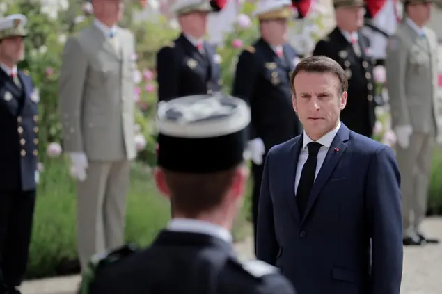 French President Emmanuel Macron reviews military troops during the ceremony of his inauguration for a second term at the Elysee palace, in Paris, France, Saturday, May 7, 2022. Macron was reelected for five years on April 24 in an election runoff that saw him won over far-right rival Marine Le Pen. (AP Photo/Lewis Joly)