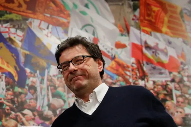 The League Giancarlo Giorgetti arrives at the party headquarters in Milan to comment first electoral results, Monday night, March 5, 2018. More than 46 million Italians were voting Sunday in a general election that is being closely watched to determine if Italy would succumb to the populist, anti-establishment and far-right sentiment that has swept through much of Europe in recent years. (AP Photo/Antonio Calanni)