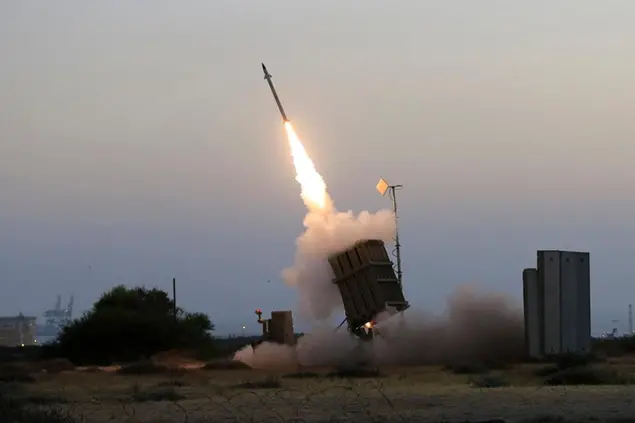 FILE - In this July 5, 2014 file photo, an Iron Dome air defense system fires to intercept a rocket from Gaza Strip in the costal city of Ashkelon, Israel. The Israeli Defense Ministry said Tuesday, March 16, 2021 that the Iron Dome air defense system has been upgraded and is now capable for intercepting rocket and missile salvos as well as simultaneous attacks by unmanned aerial vehicles. (AP Photo/Tsafrir Abayov, File)