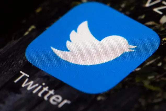 FILE - This April 26, 2017, file photo shows the Twitter app icon on a mobile phone in Philadelphia. Former Ku Klux Klan leader David Duke has been banned from Twitter for breaking the social media platform's site’s rules forbidding hate speech. The company said Friday, July 31, 2020 that Duke's account “has been permanently suspended for repeated violations of the Twitter Rules on hateful conduct.” (AP Photo/Matt Rourke, File)