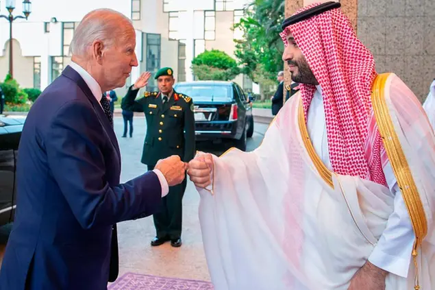 In this photo released by Saudi Press Agency (SPA), Saudi Crown Prince Mohammed bin Salman, right, greets President Joe Biden, with a fist bump after his arrival in Jeddah, Saudi Arabia, Friday, July 15, 2022. (Saudi Press Agency via AP)