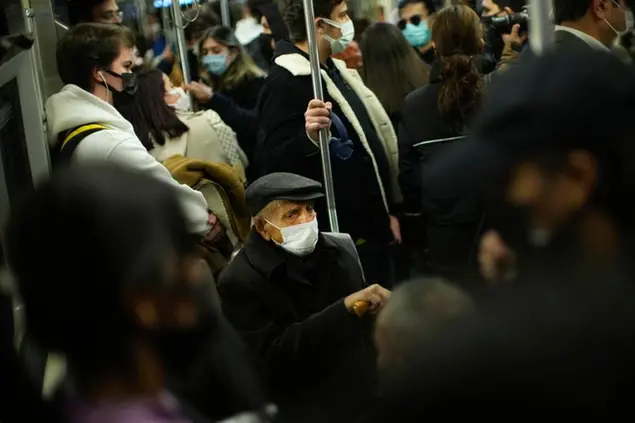 People, all wearing masks to prevent the spread of the COVID-19, take a ride in a metro in Istanbul, Turkey, Thursday, Dec. 2, 2021. The coronavirus's omicron variant kept a jittery world off-kilter Wednesday, as reports of infections linked to the mutant strain cropped up in more parts of the globe, and one official said that the wait for more information on its dangers felt like \\\"an eternity\\\". (AP Photo/Francisco Seco)