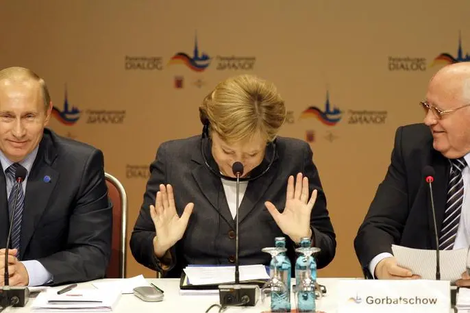 German Chancellor Angela Merkel, center, gestures as she, Russian President Vladimir Putin, left, and former President of the Soviet Union, Mikhail Gorbachev, right, attend the Petersburg Dialogue at the Kurhaus resort in Wiesbaden, Germany, Monday, Oct. 15, 2007. Putin is on a two-day visit to Germany for talks between Germany and Russia. (AP Photo/Anja Niedringhaus)