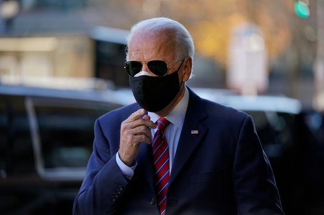 President-elect Joe Biden walks to speak to media as he arrives to meet virtually with the United States Conference of Mayors at The Queen theater Monday, Nov. 23, 2020, in Wilmington, Del. (AP Photo/Carolyn Kaster)