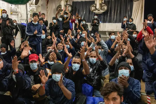 Migrants prepare to disembark from the Norway-flagged Geo Barents rescue ship after having been allowed by Italian authorities, in Catania's port, Sicily, southern Italy, Tuesday, Nov. 8, 2022. While the Geo Barents was allowed to disembark all its migrants, the German-flagged Humanity1 is still at harbor in Catania with 35 aboard still waiting for permission, and another rescue ship, the Ocean Viking is appealing France for a safe port. (AP Photo/Massimo Di Nonno)