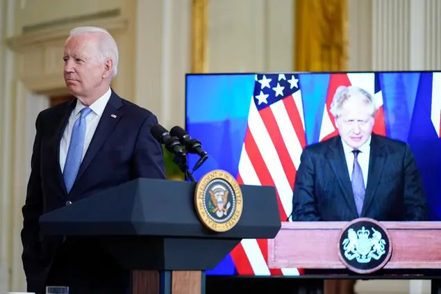 President Joe Biden, listens as he is joined virtually by Australian Prime Minister Scott Morrison and British Prime Minister Boris Johnson, right, to speak about a national security initiative from the East Room of the White House in Washington, Wednesday, Sept. 15, 2021. (AP Photo/Andrew Harnik)