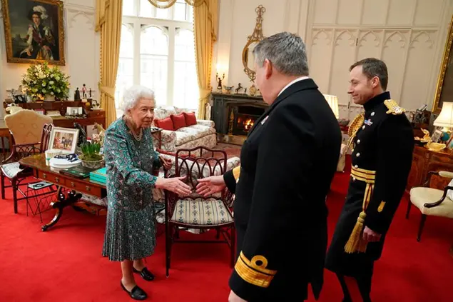 Britain's Queen Elizabeth II speaks with Rear Admiral James Macleod and Major General Eldon Millar, right, as she meets the incoming and outgoing Defence Service Secretaries, Wednesday Feb. 16, 2022. Rear Admiral Macleod relinquished his appointment as Defence Services Secretary as Major General Millar assumed the role. (Steve Parsons, Pool via AP)