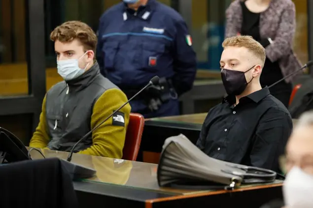 Gabriel Natale-Hjorth, from the United States, left, and his co-defendant Finnegan Lee Elder wear face masks to curb the spread of COVID-19 as they sit at the start of a hearing in the trial where they are facing murder charges after Italian Carabinieri paramilitary police officer Mario Cerciello Rega was fatally stabbed on a Rome street in July 2019, in Rome, Monday, April 26, 2021. (Remo Casilli/Pool Photo via AP)